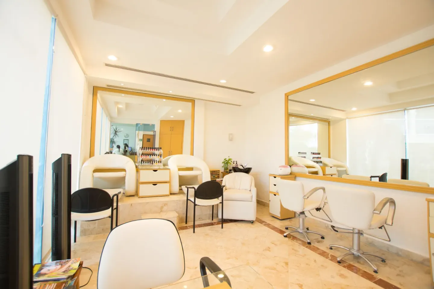 Spa salon with styling chairs and manicure stations at Occidental Costa Cancún.