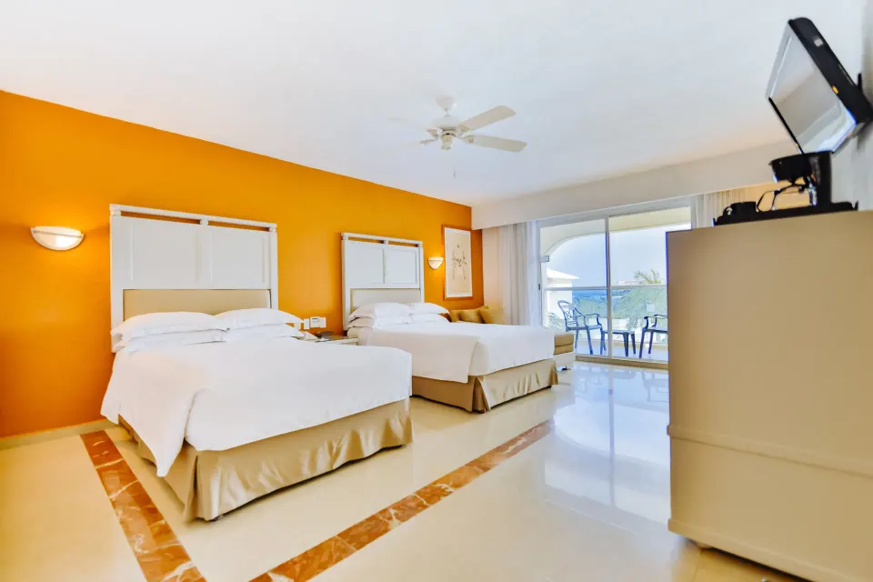 2x2 interconnecting room with two double beds and balcony at Occidental Costa Cancún.