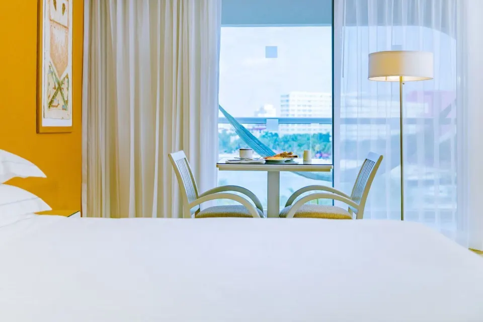 Room with Terrace bed and sitting area by the window at Occidental Costa Cancún.