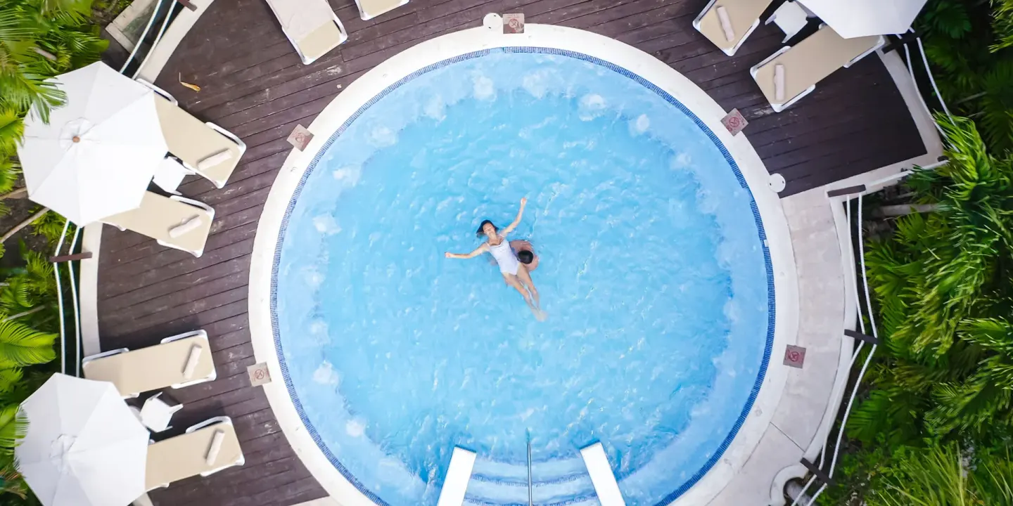 Overhead view of guests floating in a round pool at Occidental Cozumel.