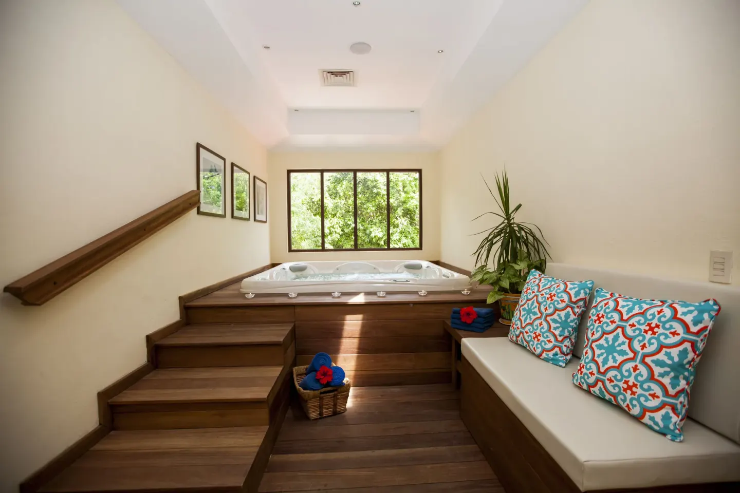 Indoor spa whirlpool with bench seating and colorful pillows at Occidental Cozumel.