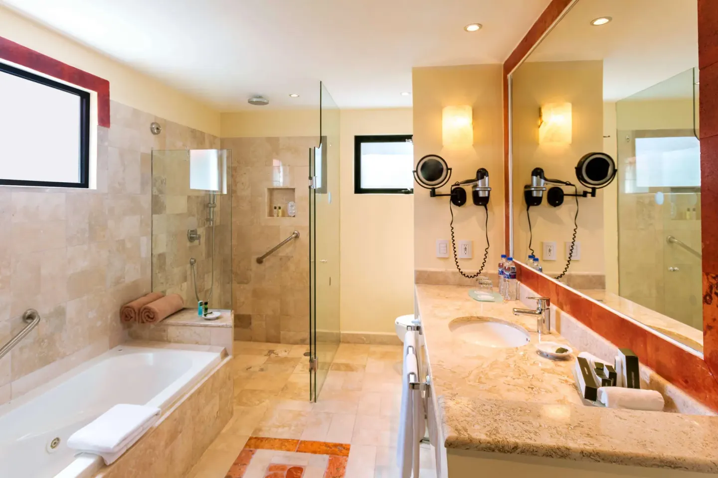 Royal Level Luxury bathroom with tub and glass shower at Occidental Cozumel.