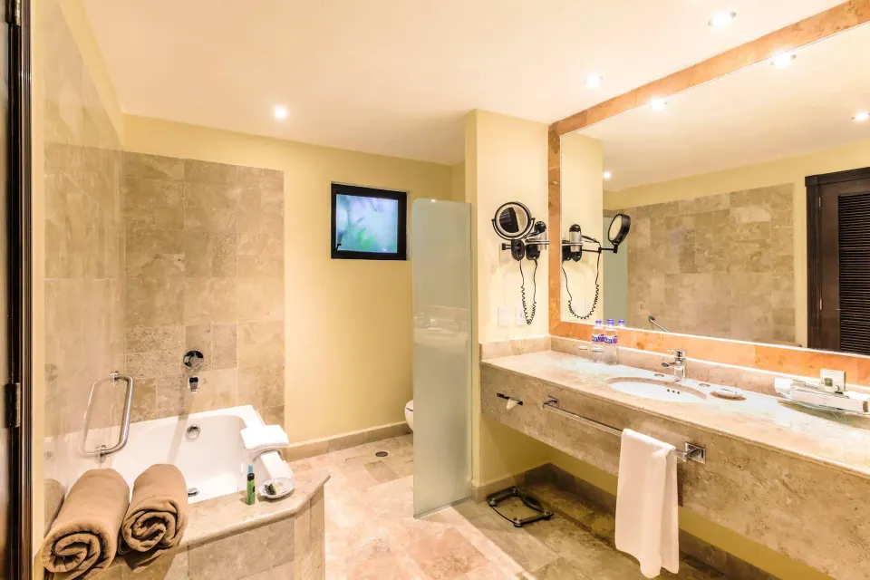 Royal Level Luxury bathroom with tub and vanity at Occidental Cozumel.
