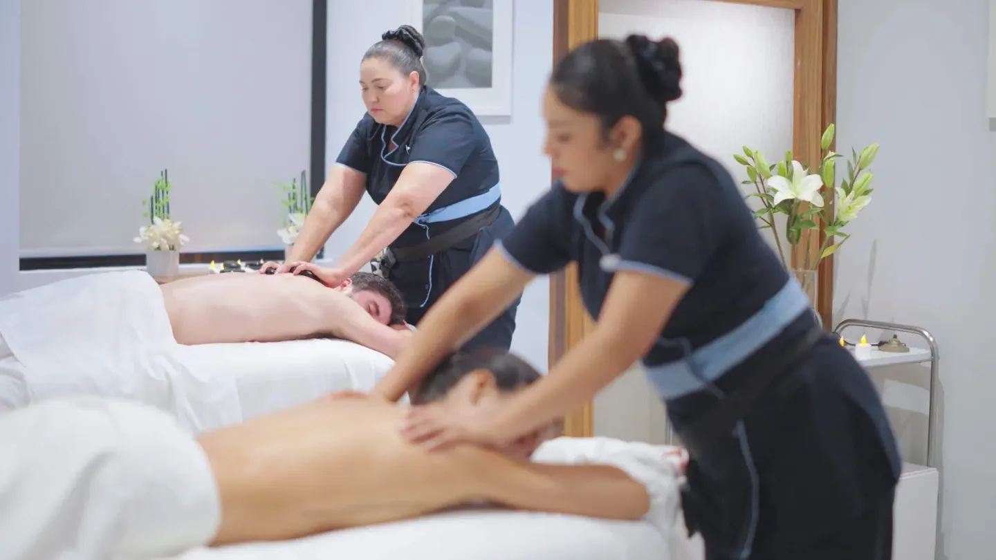 Therapists give massages on two tables in a spa room at Occidental Nuevo Vallarta.