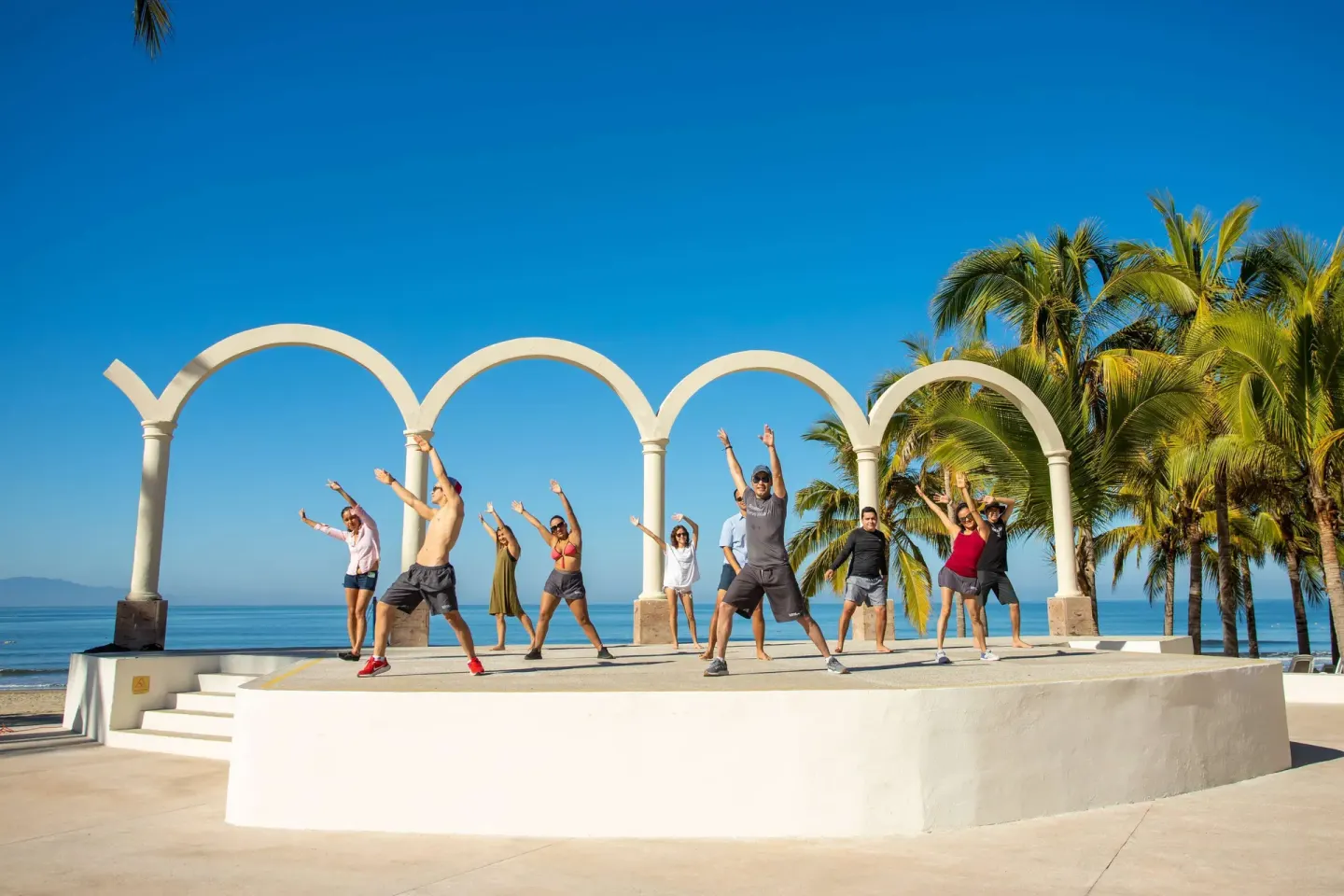 Guests exercise on an oceanfront terrace at Occidental Nuevo Vallarta.