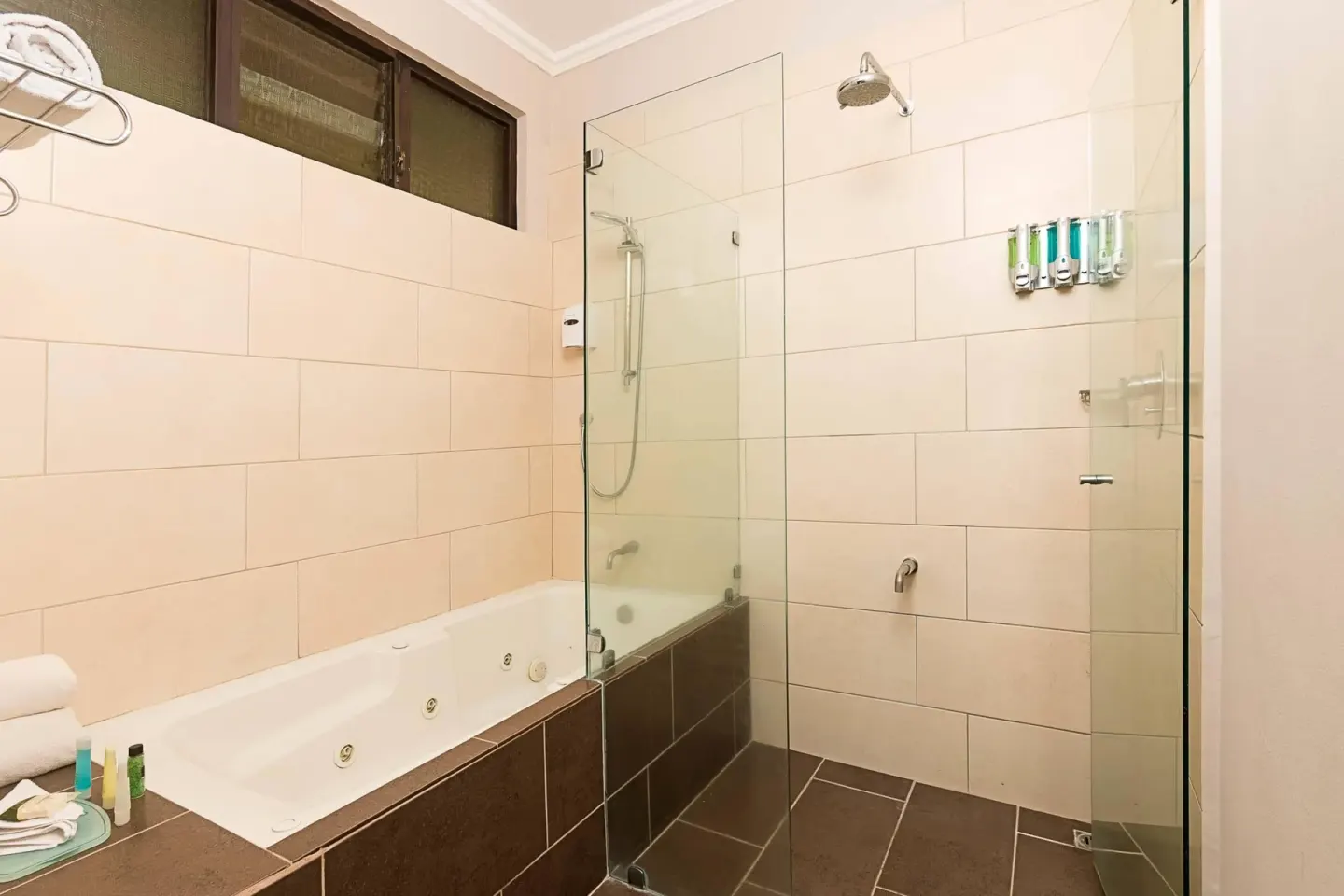 Bathroom with soaking tub and glass shower enclosure at Occidental Papagayo.