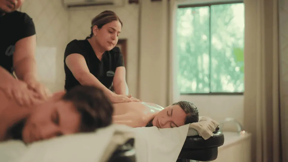 Massage therapists treating guests in a spa room at Occidental Papagayo.