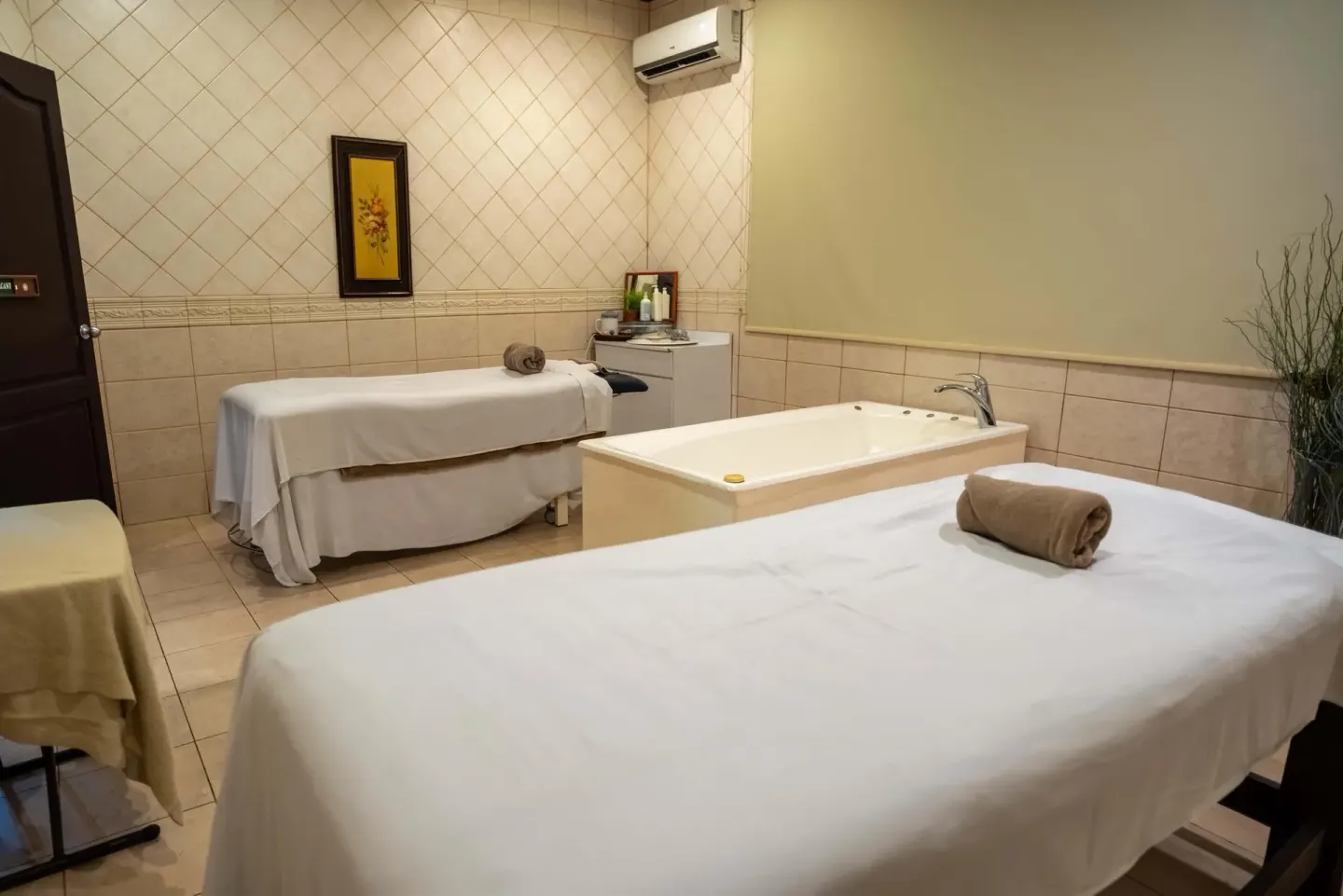Spa treatment room with massage tables and a soaking tub at Occidental Papagayo.