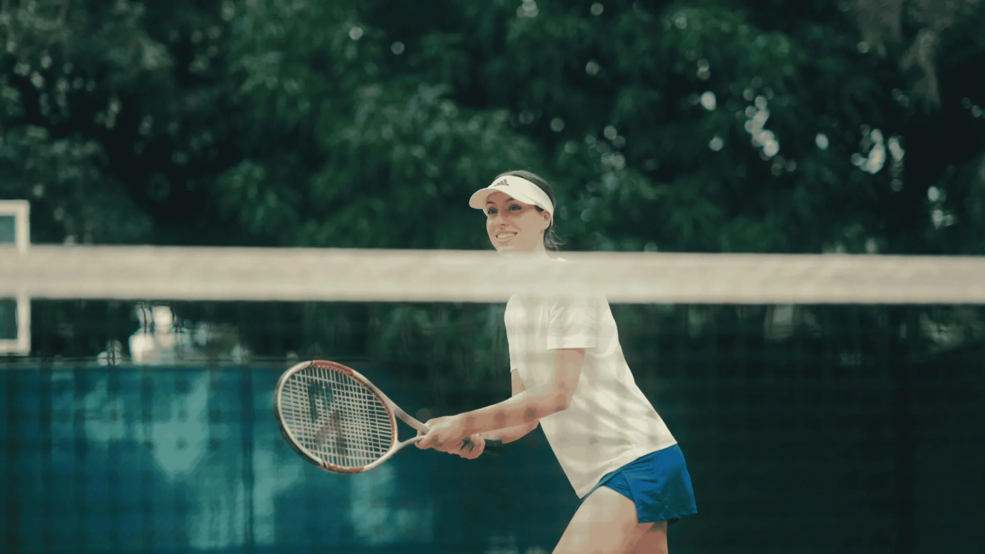 A guest returns a shot on the tennis court at Occidental Papagayo.