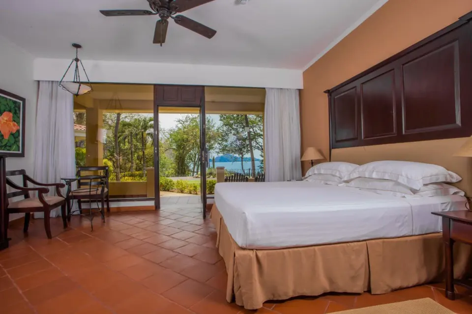 Deluxe Room Bay View with bed and glass doors at Occidental Papagayo.