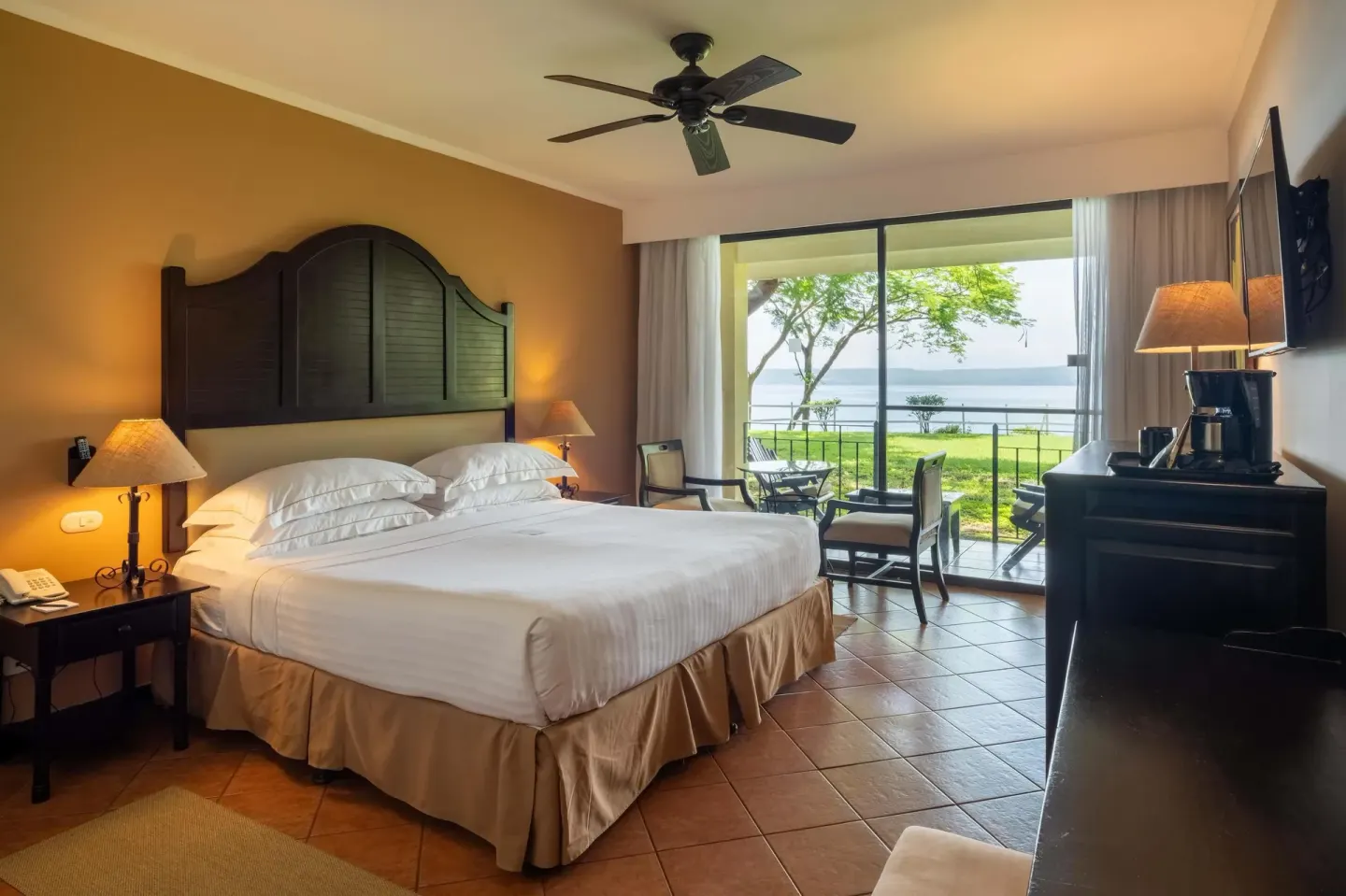 Deluxe Room Bay View with king bed and terrace at Occidental Papagayo.