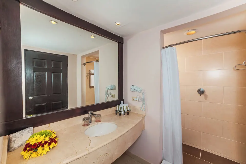 Deluxe Room bathroom vanity and shower curtain at Occidental Papagayo.