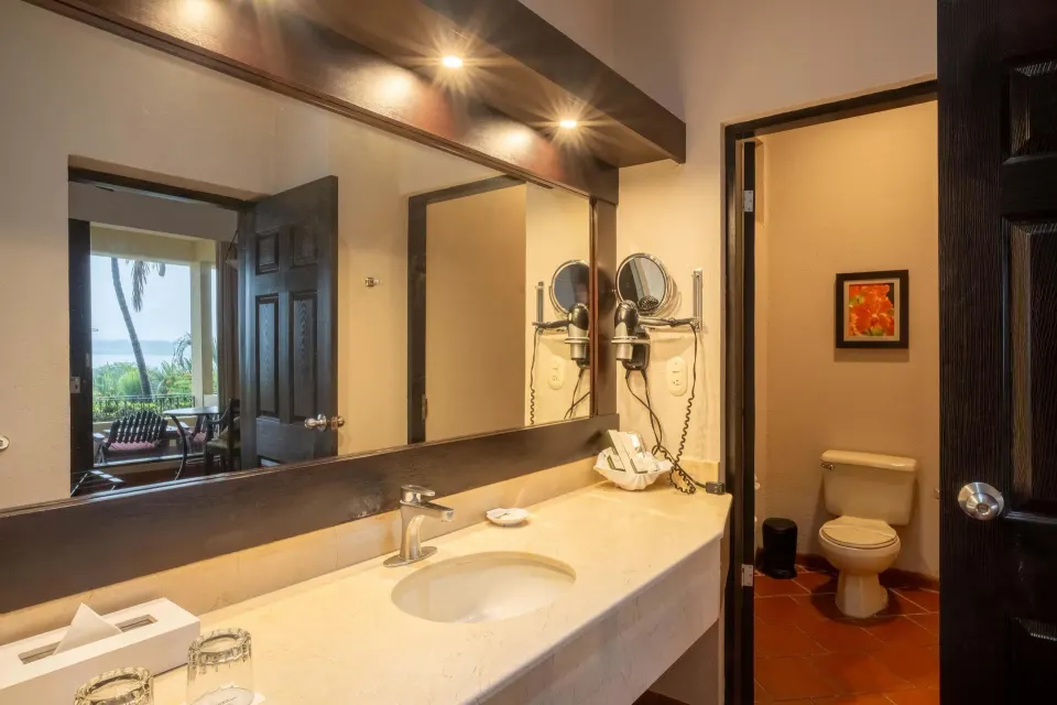 Premium Level Luxury bathroom vanity with separate toilet area at Occidental Papagayo.