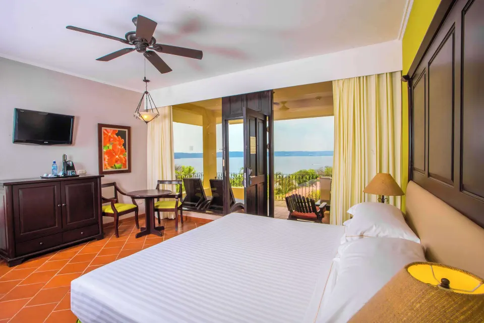 Premium Level Luxury king room with balcony seating and ocean view at Occidental Papagayo.