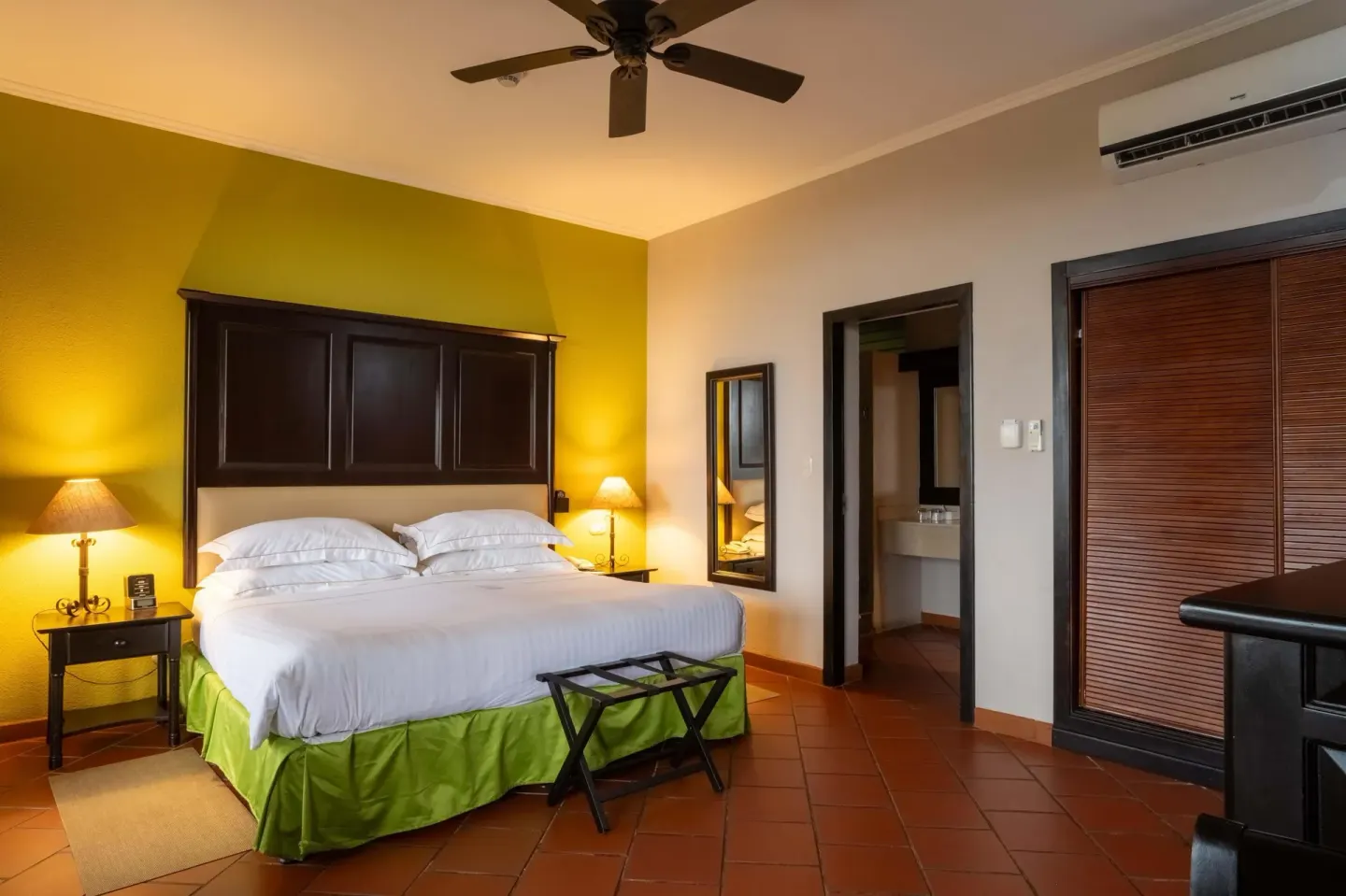 Premium Level Luxury king room with wardrobe and bathroom doorway at Occidental Papagayo.