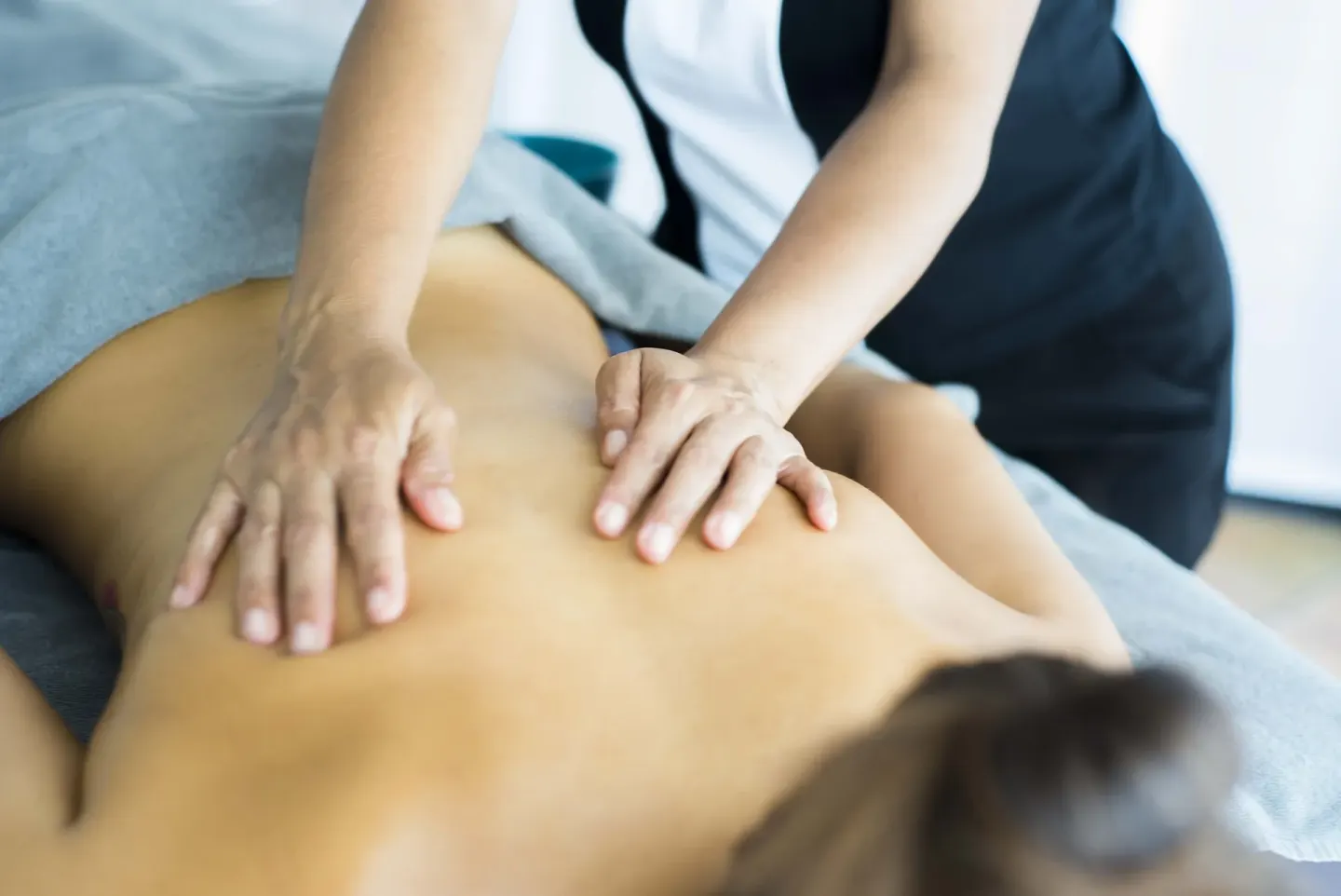 Massage treatment close-up with therapist hands on a guest at Occidental Punta Cana.