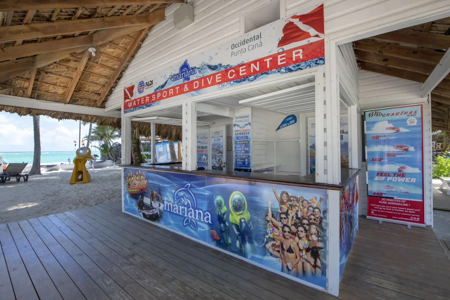 Watersport and dive center counter with activity posters at Occidental Punta Cana.