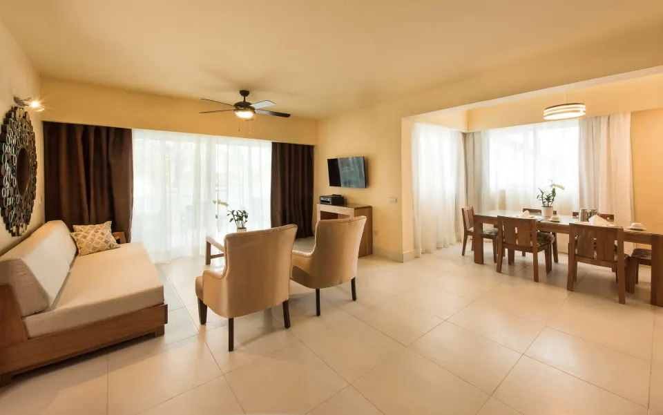 Royal Level Suite lounge and dining room with sofa at Occidental Punta Cana.