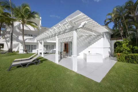 Royal Level Suite terrace and lawn with loungers at Occidental Punta Cana.
