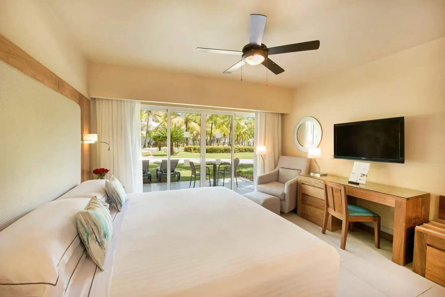 Superior Room with king bed, garden-facing terrace, desk and TV at Occidental Punta Cana.