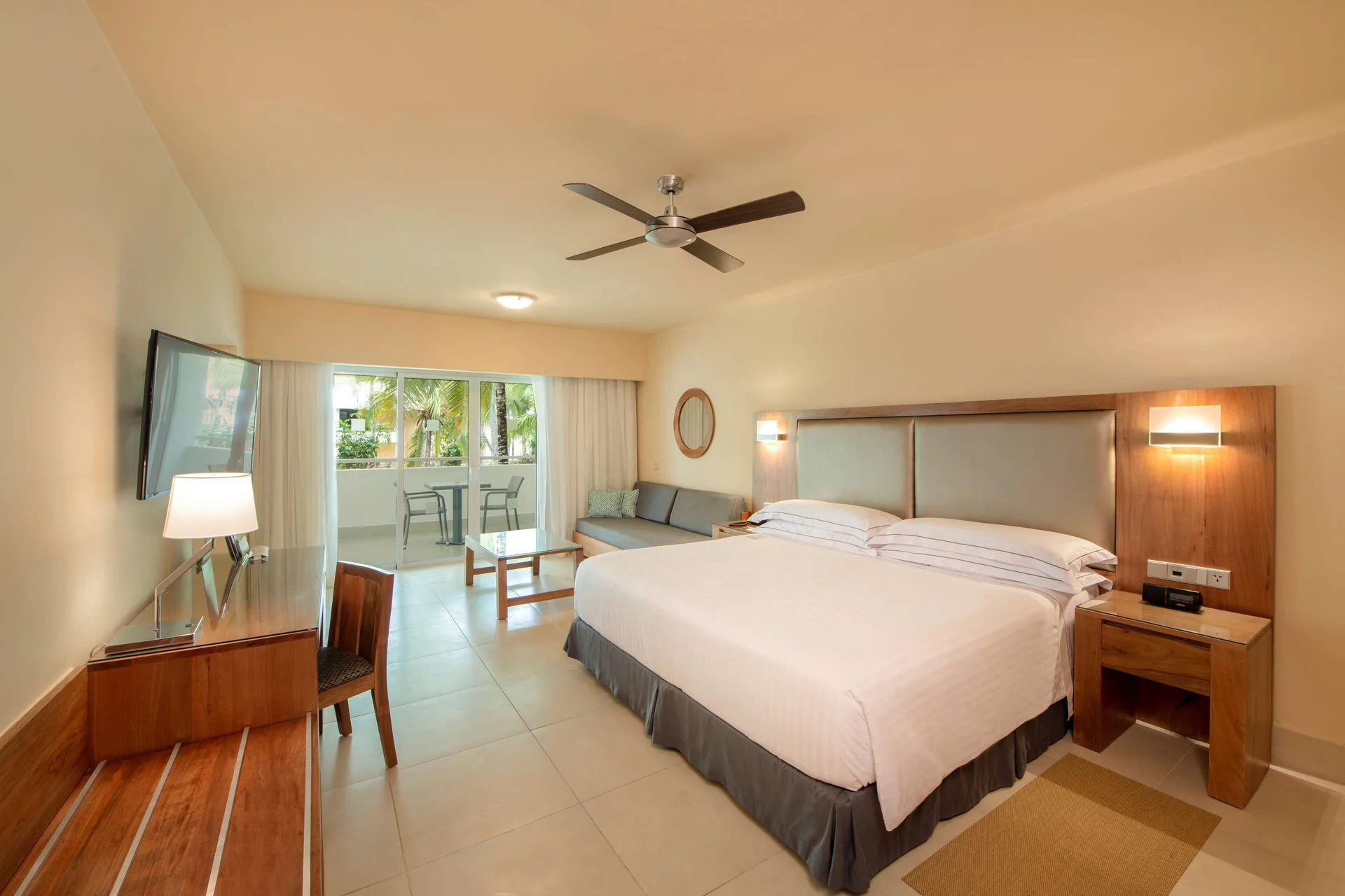 Superior Room Oceanfront with king bed, balcony doors and seating area at Occidental Punta Cana.