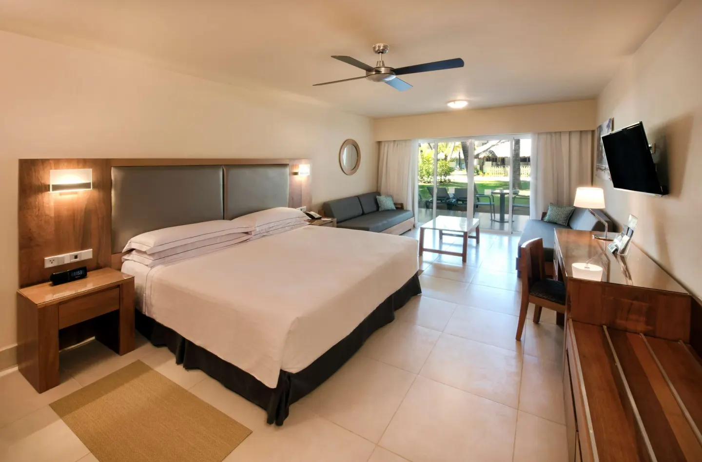 Superior Room with king bed and patio doors at Occidental Punta Cana.