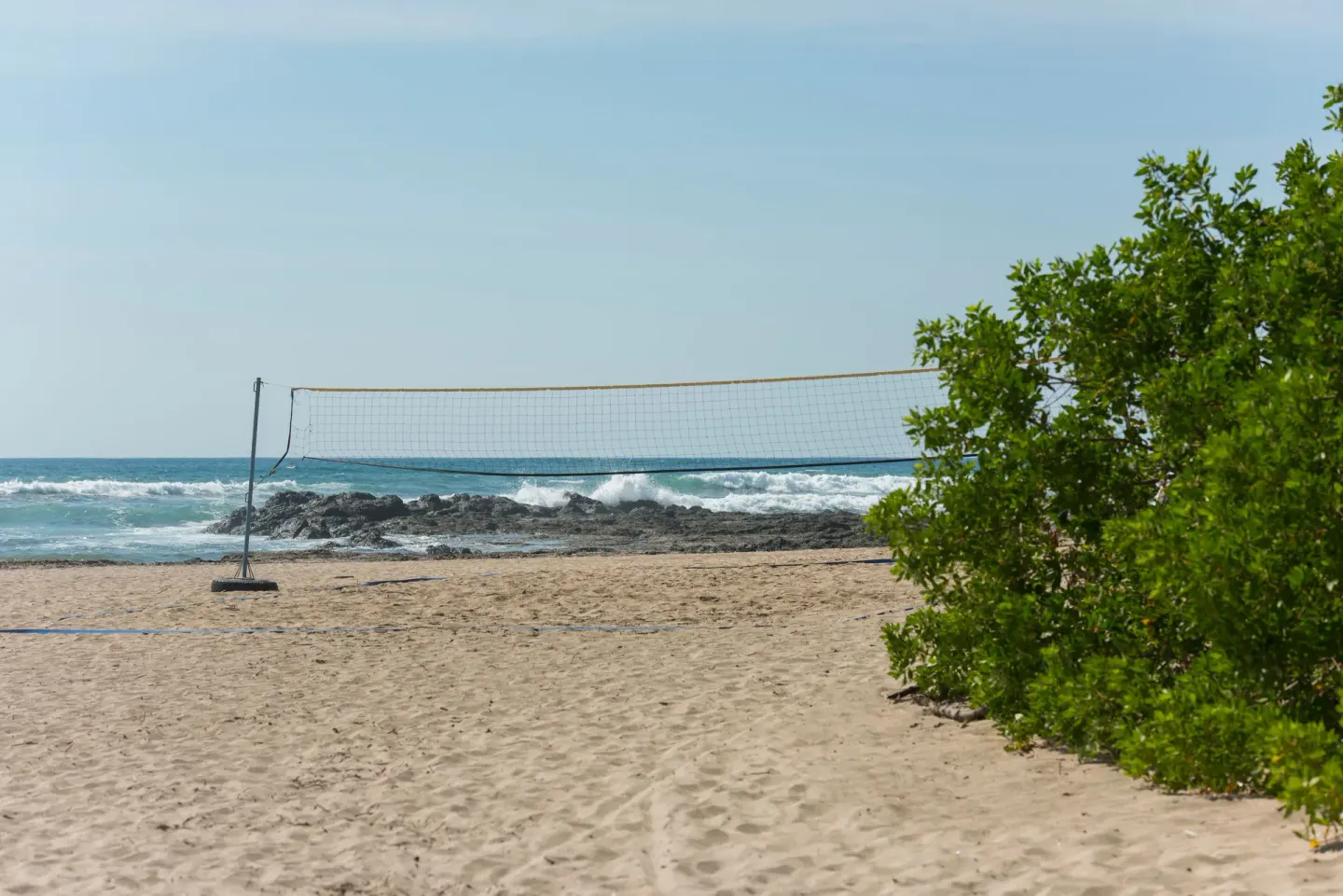 Beach volleyball net on the sand by the ocean at Occidental Tamarindo.