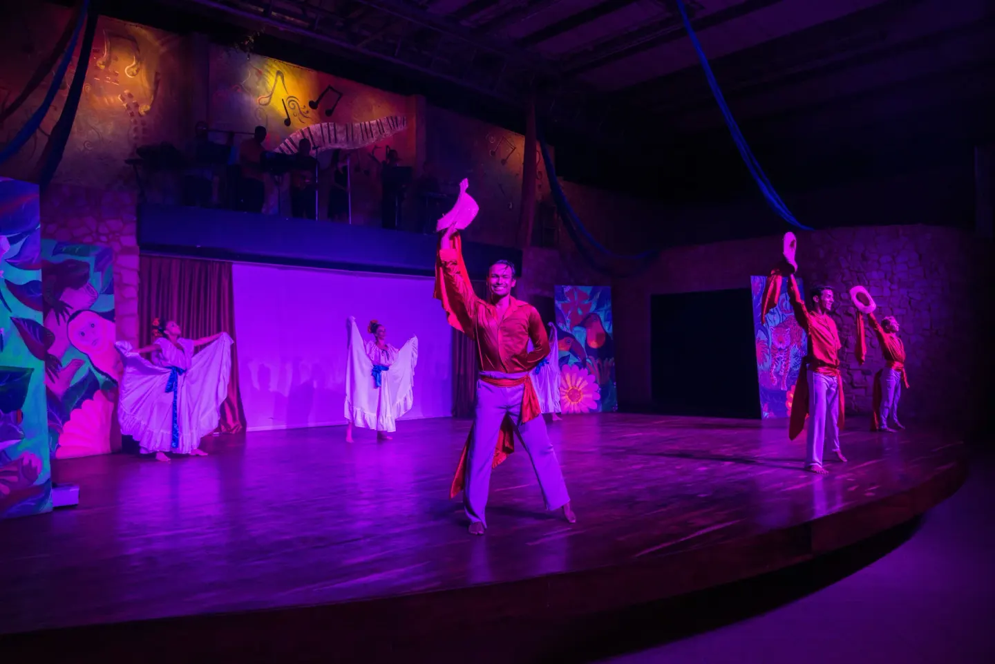 Dancers perform under purple stage lighting at Occidental Tamarindo.