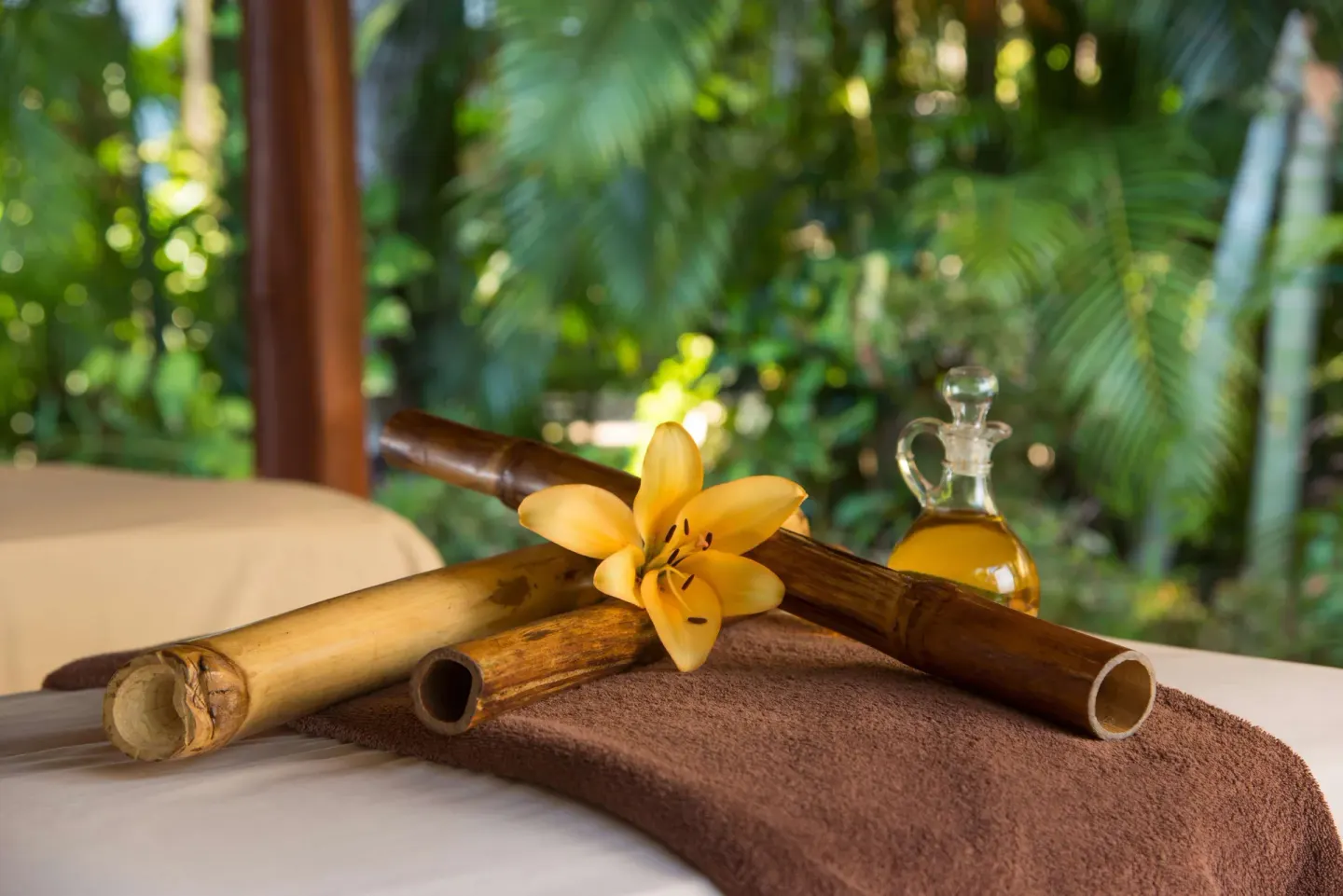 Massage table detail with bamboo, flower, and oil bottle at Occidental Tamarindo.