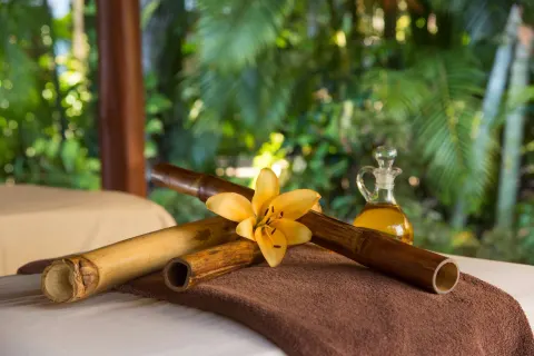 Massage table detail with bamboo, flower, and oil bottle at Occidental Tamarindo.