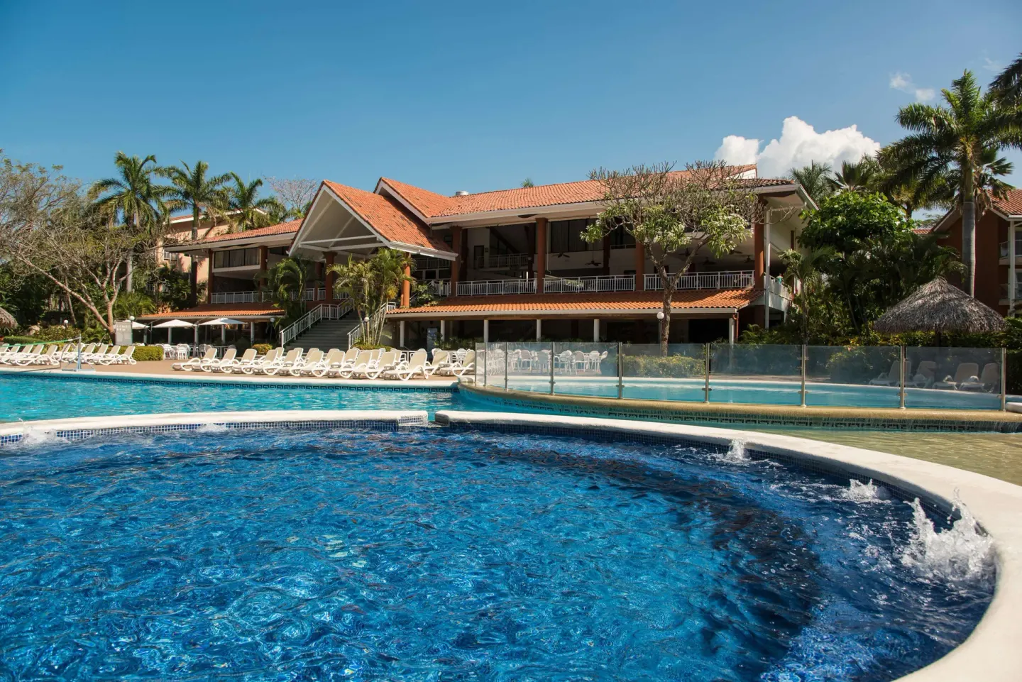 Pool complex with fountain features and resort building at Occidental Tamarindo.