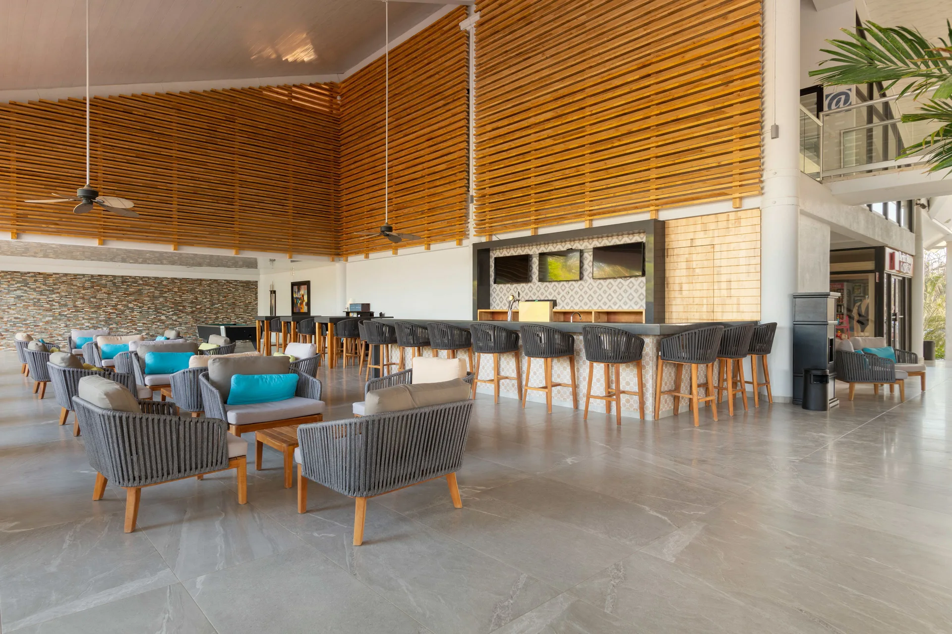 Modern lobby bar lounge with high ceilings at Occidental Tamarindo.