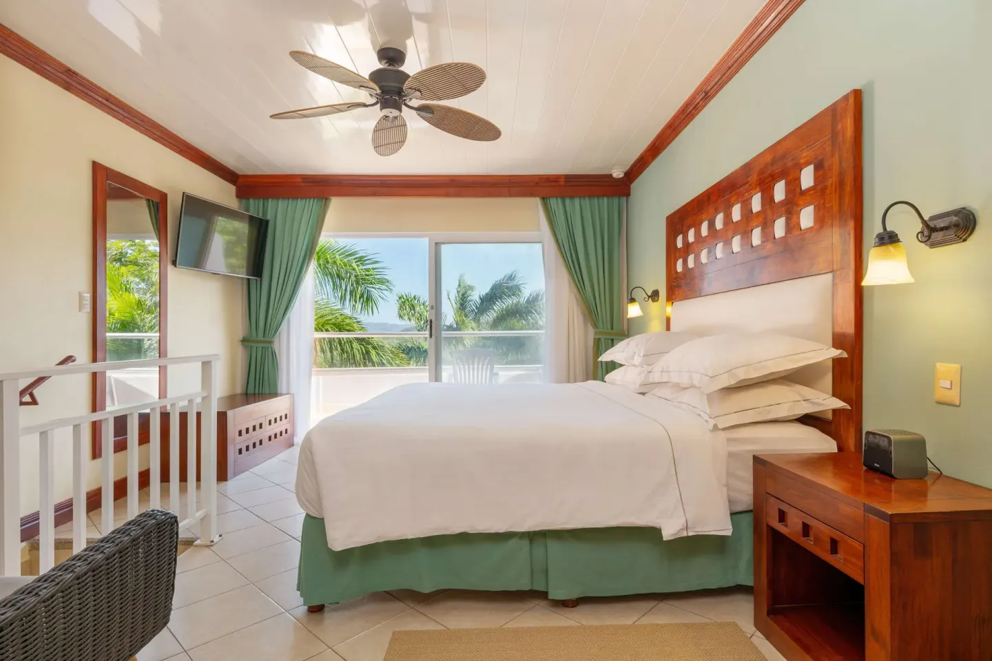 Duplex suite bedroom with king bed and balcony view at Occidental Tamarindo.