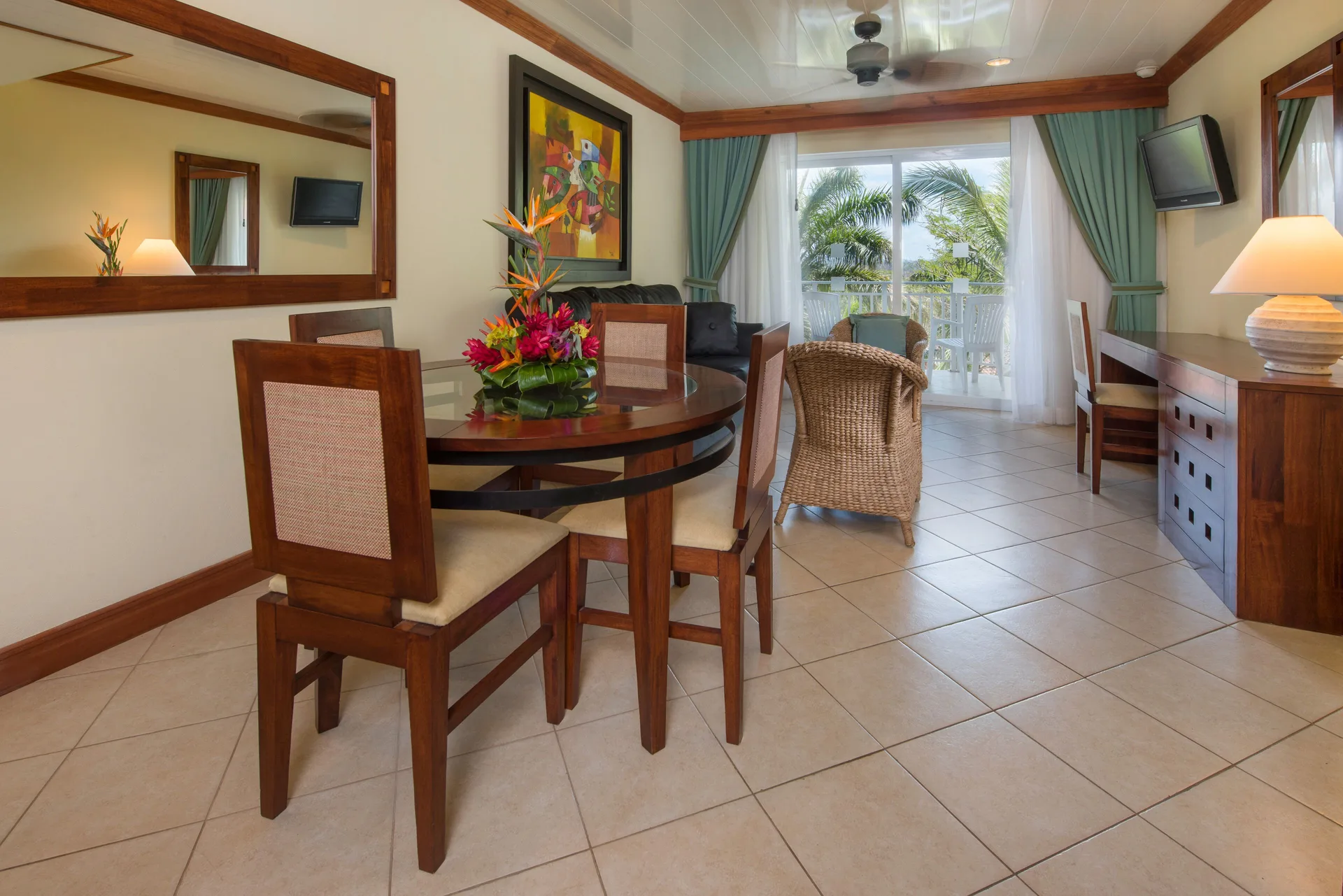 Duplex suite living and dining area with balcony doors at Occidental Tamarindo.