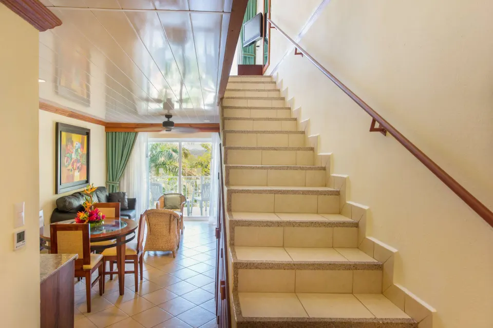 Duplex suite staircase leading from the living area at Occidental Tamarindo.