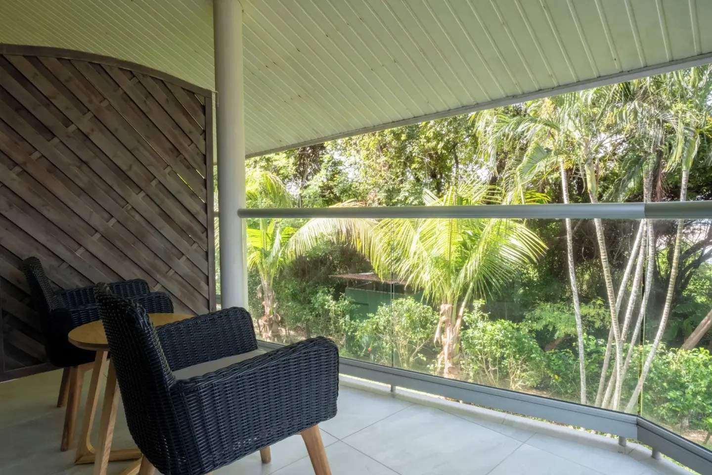 Superior Room balcony seating with tropical greenery at Occidental Tamarindo.