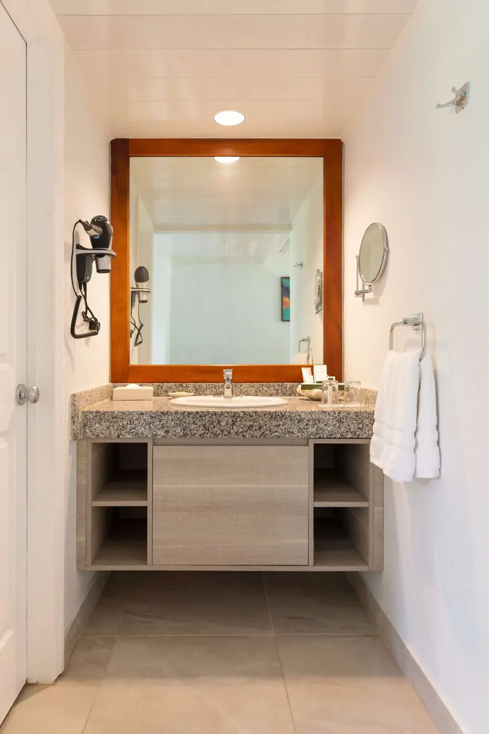 Superior Room bathroom vanity with mirror and towels at Occidental Tamarindo.