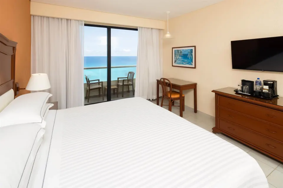 King guest room with balcony and turquoise ocean view at Occidental Tucancún.