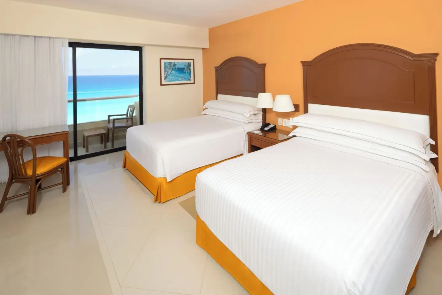 Two-bed ocean-view guest room with balcony at Occidental Tucancún.