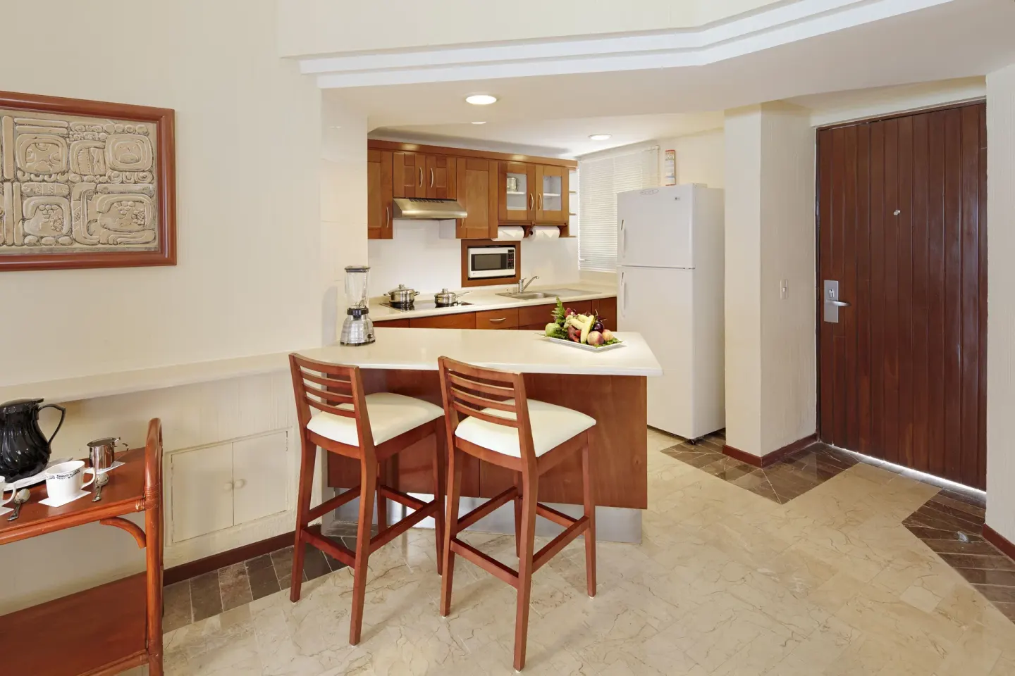 Premium Suite Oceanfront kitchenette with breakfast bar at Occidental Tucancún.
