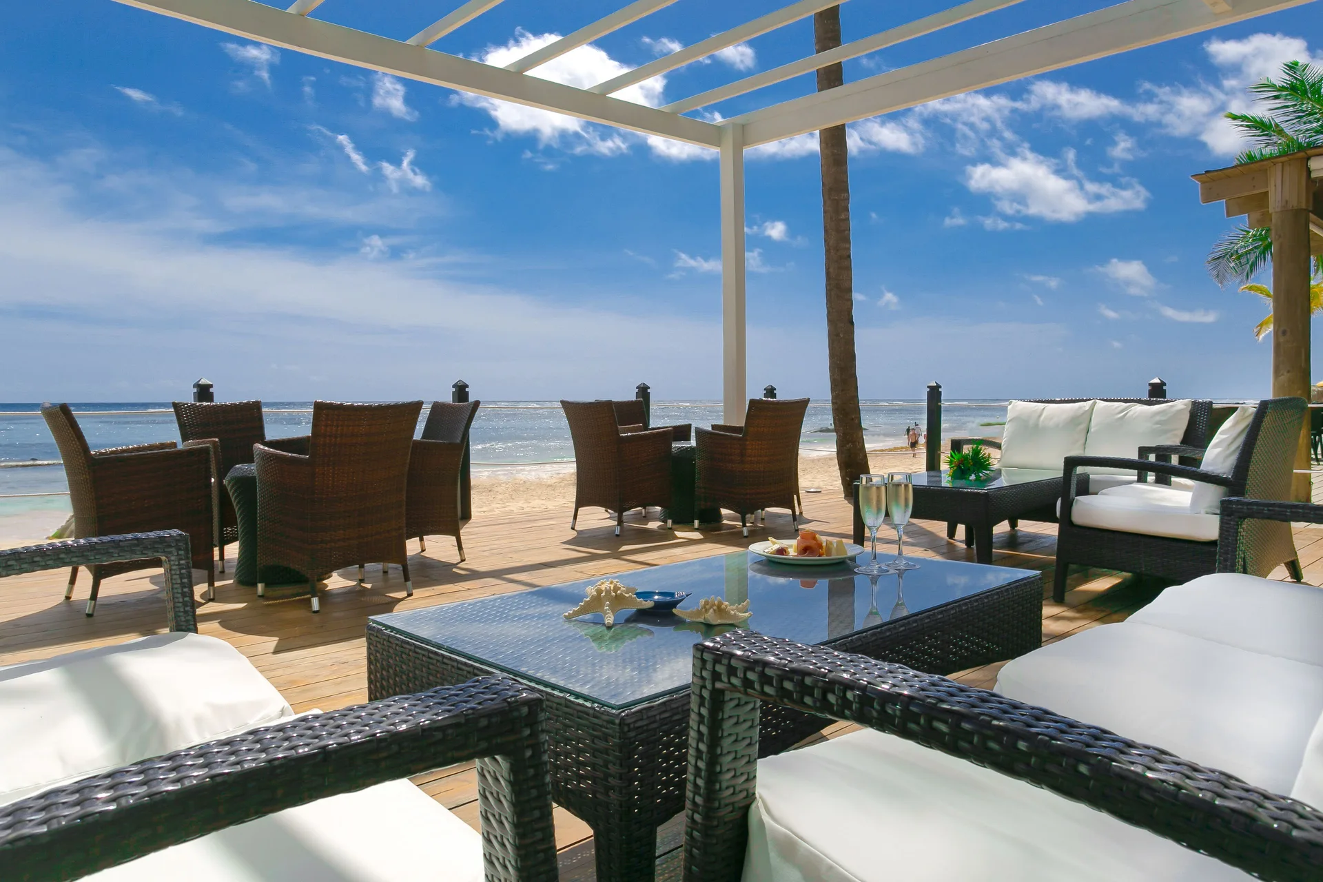 Beach deck lounge seating facing the ocean at Ocean Blue & Sand Beach Resort.