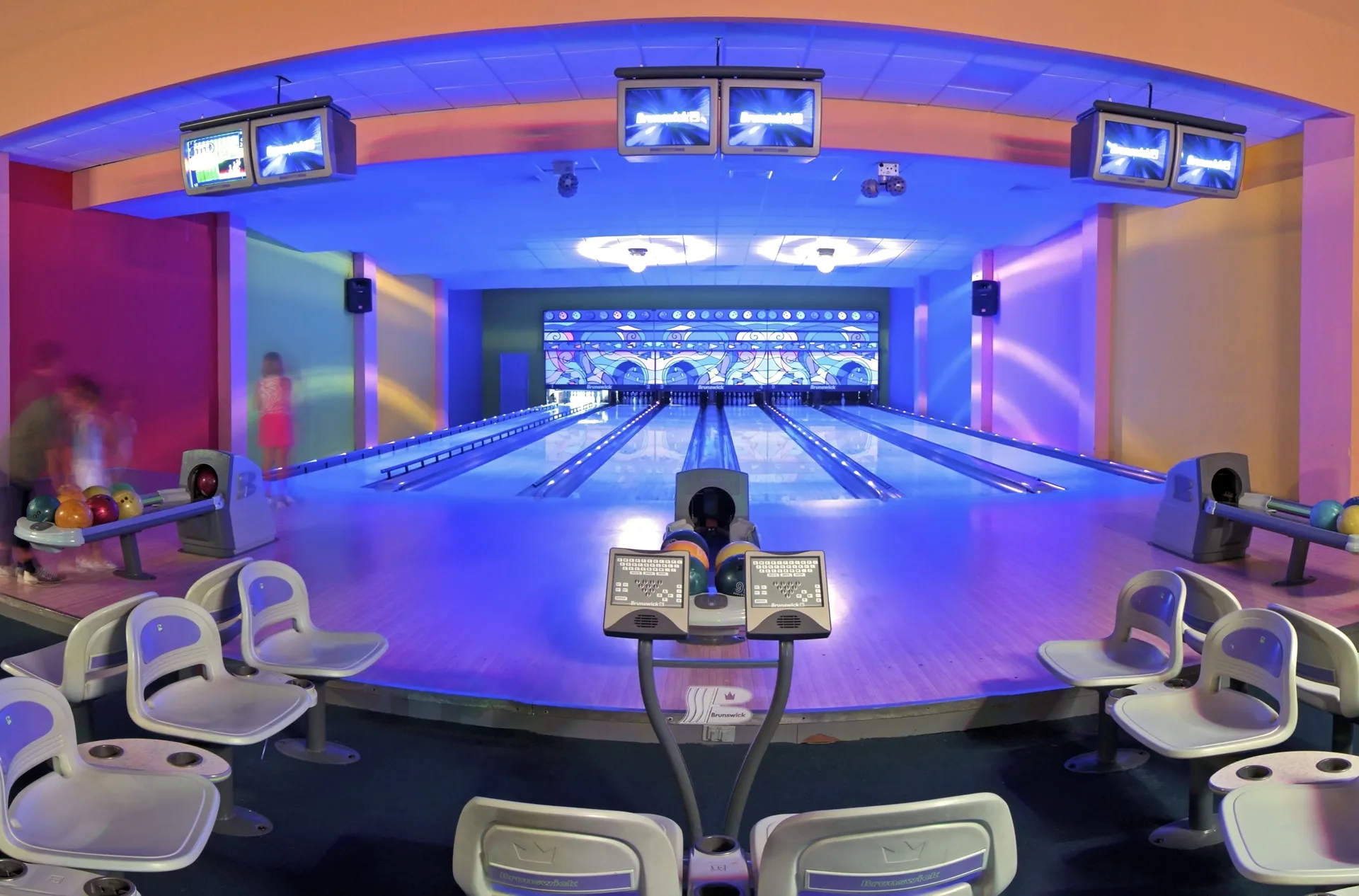 Bowling alley with blue lighting at Ocean Blue & Sand Beach Resort.