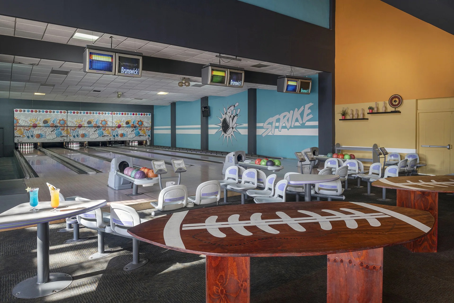 Bowling lanes and seating in the game area at Ocean Blue & Sand Beach Resort.