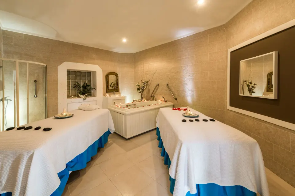 Spa treatment room with two massage tables at Ocean Blue & Sand Beach Resort.
