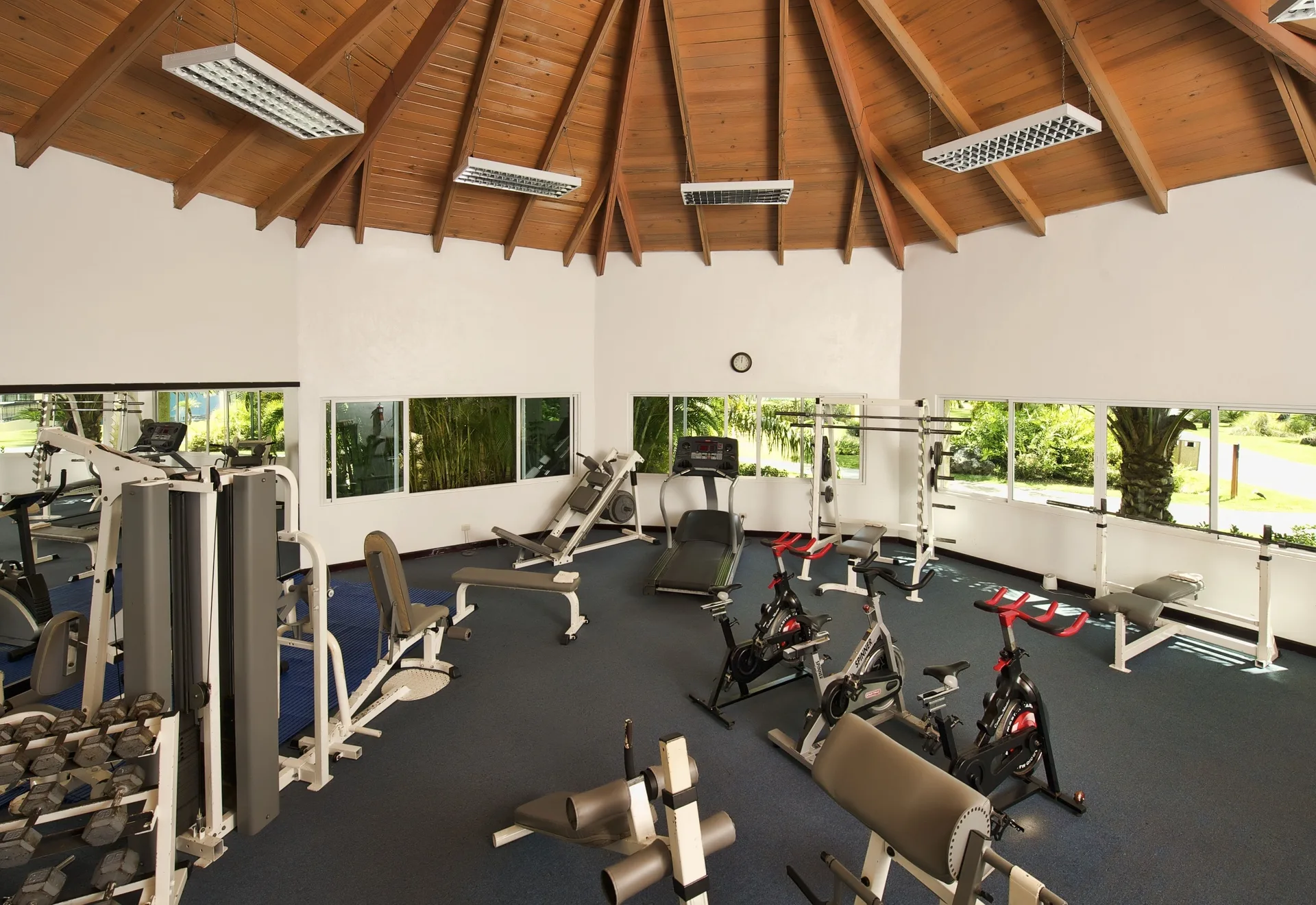 Fitness center with cardio machines and weights at Ocean Blue & Sand Beach Resort.