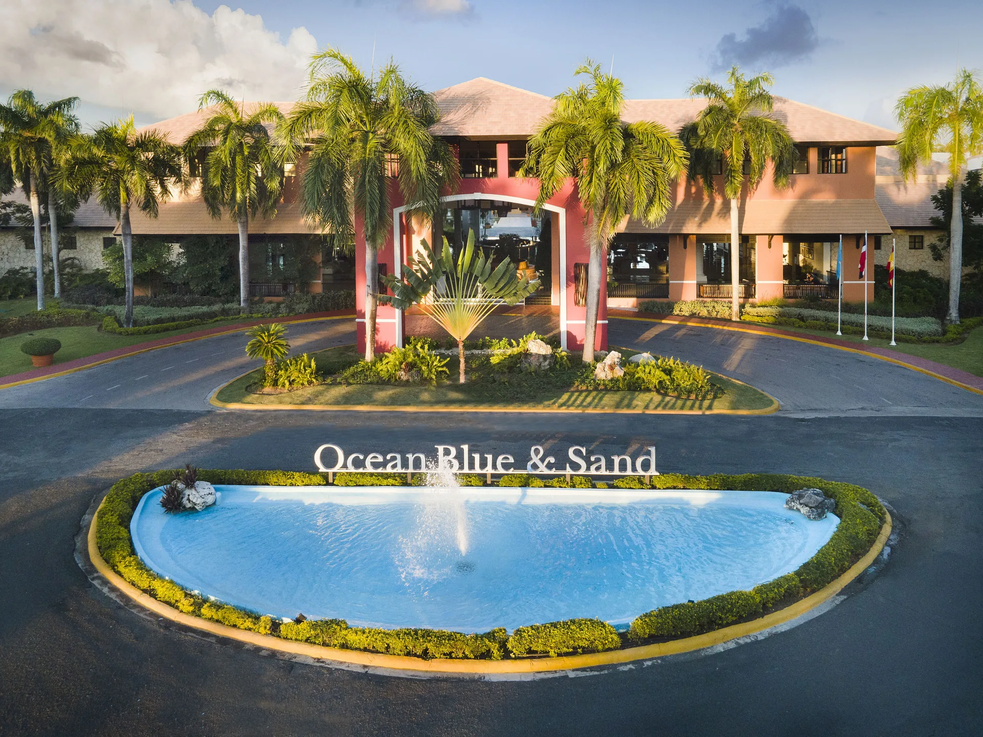 Resort entrance with fountain and sign at Ocean Blue & Sand Beach Resort.