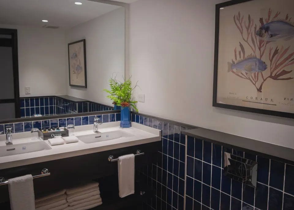 Junior Suite Nature View bathroom vanity with blue tile at Ocean Blue & Sand Beach Resort.