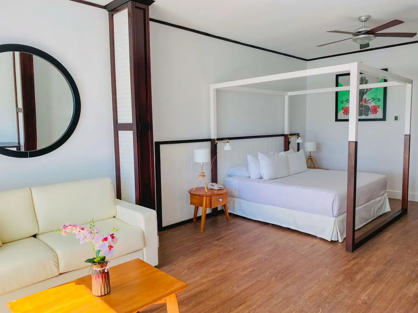 Junior Suite Nature View with canopy bed and sofa at Ocean Blue & Sand Beach Resort.