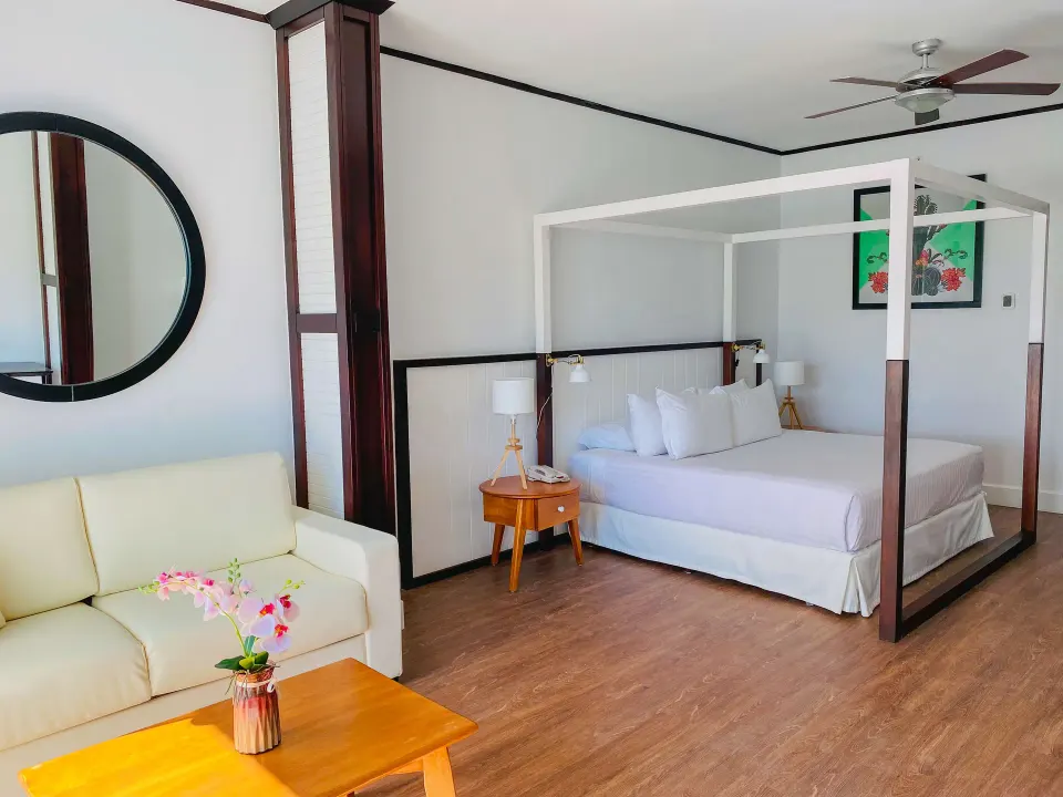 Junior Suite Nature View with canopy bed and sofa at Ocean Blue & Sand Beach Resort.