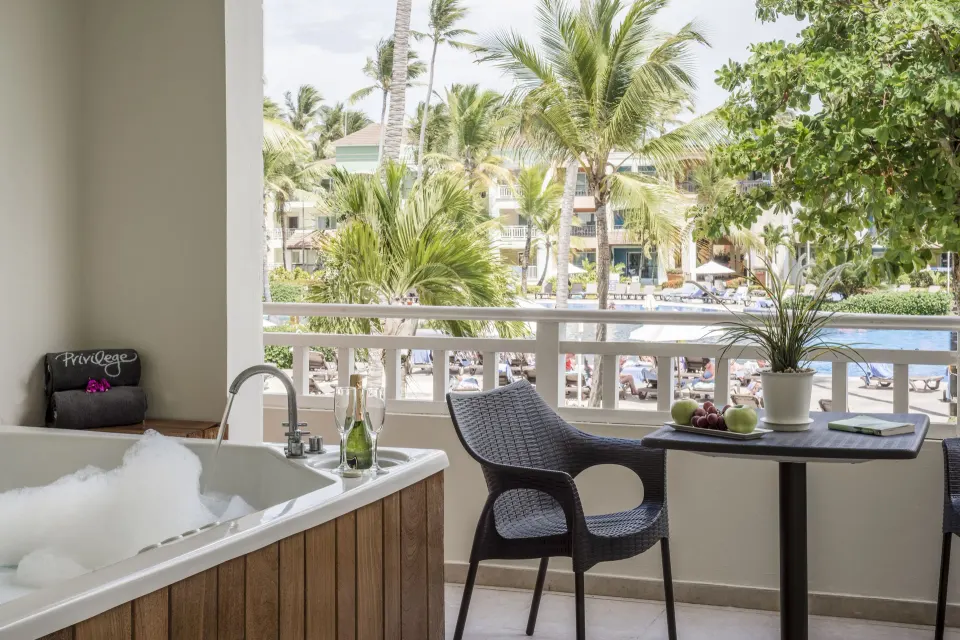 Balcony with whirlpool tub and pool view at Ocean Blue & Sand Beach Resort.